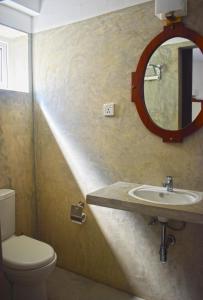 a bathroom with a sink and a mirror at City Beds Colombo in Colombo