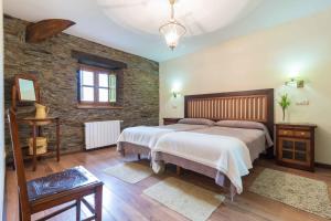 Кровать или кровати в номере Apartamentos Rurales Sierra