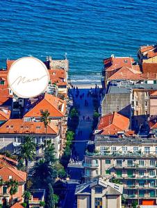 a city with a large clock on top of buildings at Residenza Nam in Alassio
