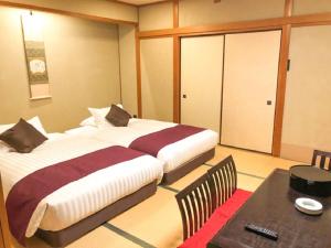 Postel nebo postele na pokoji v ubytování LiVEMAX RESORT Jogasaki Kaigan