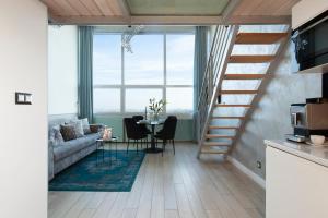 a living room with a couch and a table with chairs at Panorama- the View of Gdańsk by Elite Apartments in Gdańsk