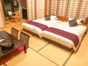 Postel nebo postele na pokoji v ubytování LiVEMAX RESORT Jogasaki Kaigan