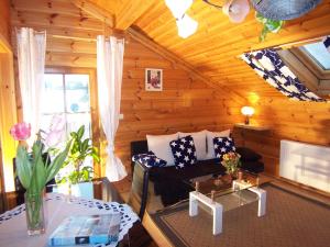 a living room with a couch and a table at Ferienhaus-Hotel "Zur Grünen Oase" in Adelmannsfelden