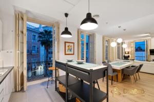 a kitchen and dining room with a table and a dining room at Exclusive Málaga Soho Apartment in Málaga