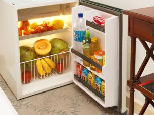 an open refrigerator filled with lots of food and drinks at Leblon The best of Brazil in Rio de Janeiro