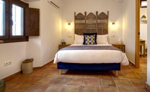 a bedroom with a large bed in a room at La Vieja Botica in Canillas de Aceituno