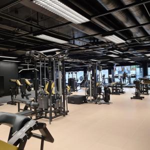 a gym with rows of exercise bikes and treadmills at Hotel Astor in Vaasa