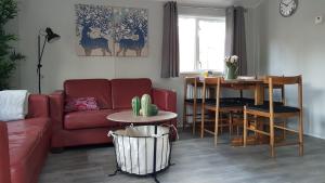 a living room with a red couch and a table at Vakantiehuis Diever in Diever