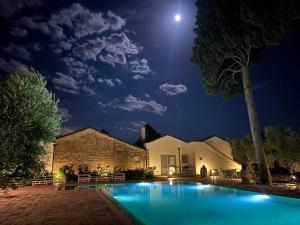 uma piscina à noite com a lua no céu em Masseria Celentano Relais & Agriturismo em San Severo