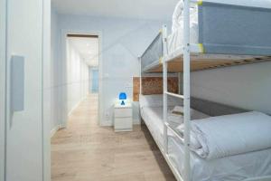 a bedroom with two bunk beds and a hallway at Cruz Victoria By Silastur in Gijón +23 photos