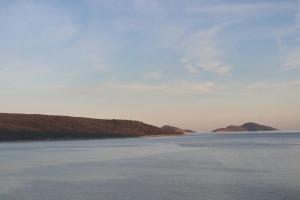 a large body of water with mountains in the background at Sossinola in Steni Vala Alonissos