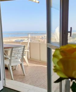 a balcony with a table and a view of the beach at La terrazza sul mare in Cesenatico