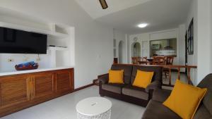 a living room with a couch and a tv at Casa Margarita in Tías