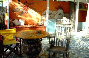 a wooden table and a chair in a room at Beachfront self-catering studios in Psatha Bay - 60km from Athens in Psatha
