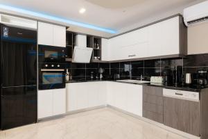 A kitchen or kitchenette at Rua Mat - Serene Villas with Modern Comfort, by ZanteWize