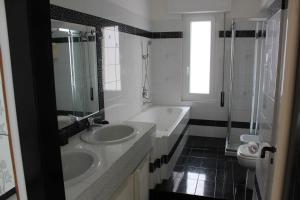 a bathroom with two sinks and a shower and a toilet at Miramare in Arma di Taggia +6 photos