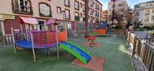 a playground with a slide and a slideintend at Les Flors !2minutos de la playa! in Lloret de Mar
