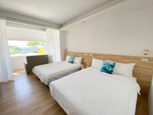 Un pat sau paturi într-o cameră la 南鴻雅築South Home