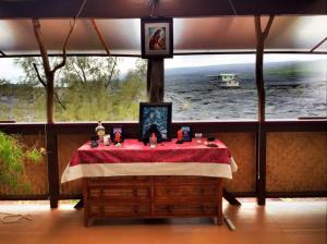 a room with a table in front of a large window at THE MAGICAL LAVA TEMPLE with EPIC Volcano Views! in Kehena