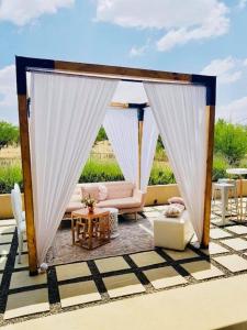 a gazebo with a couch and a table at Mont d'Or Monte Bello Estate in Bloemfontein