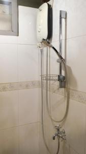 a shower with a shower head in a bathroom at Jogja ethnic house in Yogyakarta