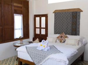 a bedroom with two beds with towels on top of it at Jogja ethnic house in Yogyakarta