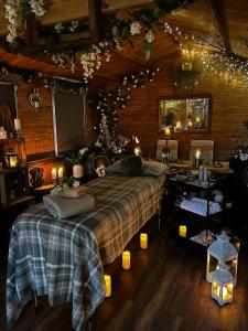 a bedroom with a large bed in a wooden cabin at Pear Tree Cottage in Bishop Auckland