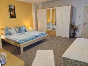 a bedroom with a large bed and a dresser at Ferienwohnung Meister in Bad Reichenhall