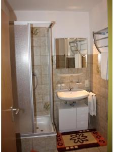 a bathroom with a shower and a sink and a tub at Ferienwohnung Meister in Bad Reichenhall