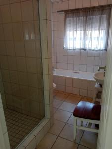 a bathroom with a shower and a sink at Sea Breeze in Stilbaai