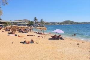 a group of people laying on a beach at Galini Palace in Athens