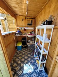 an overhead view of a kitchen in a wooden house at Cosy Glamping Yurt with log burner on our smallholding, ideal family getaway or romantic retreat in Narberth