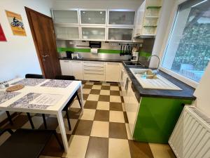 a small kitchen with a table and a sink at Rabbit apartman in Mosonmagyaróvár