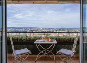 a table and chairs on a balcony with a view at S'ARD Guest House Sassari in Sassari