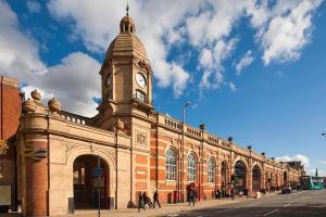 a building with a clock tower on top of it at West End House • Sleeps 8 in Leicester