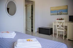 a white room with a table and a mirror at S'ARD Guest House Sassari in Sassari