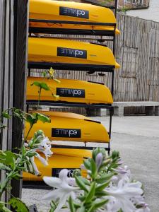 a row of yellow kayaks on a rack at Edville Studio in Ghent
