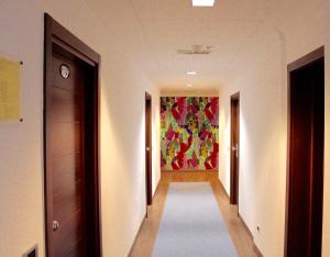 a hallway with a painting on the wall at Hotel Du Soleil in Rimini