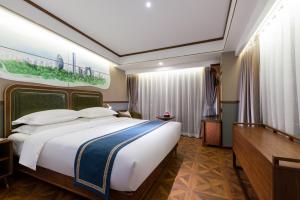 a hotel room with a large bed and a desk at Nostalgia S Hotel Beijing CCTV in Beijing