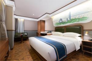 a bedroom with a large bed and a desk at Nostalgia S Hotel Beijing CCTV in Beijing