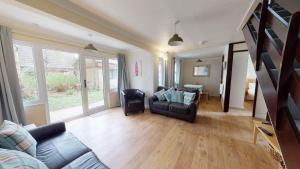 a living room with a couch and chairs and a table at 09 Trevithick Court, Tolroy Manor in Hayle