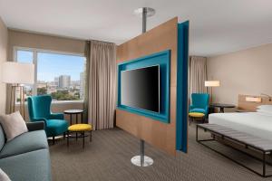 a hotel room with a bed and a flat screen tv at Hyatt Centric San Isidro Lima in Lima