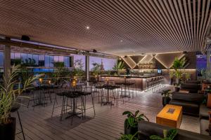 a restaurant with tables and chairs and a bar at Hyatt Centric San Isidro Lima in Lima
