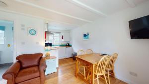 a kitchen and dining room with a table and chairs at 31 Tudor Court, Tolroy Manor in Hayle