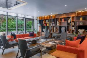 a living room with orange chairs and a table at Hyatt Centric Las Condes Santiago in Santiago