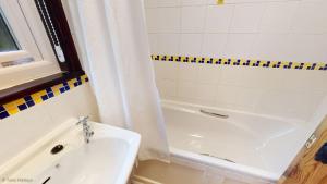 a bathroom with a sink and a tub and a shower at 01 Tudor Court, Tolroy Manor in Hayle +9 photos