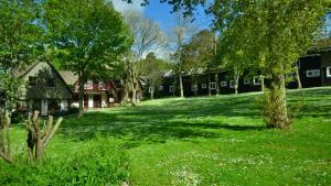 a green yard with houses and trees and grass at 01 Tudor Court, Tolroy Manor in Hayle