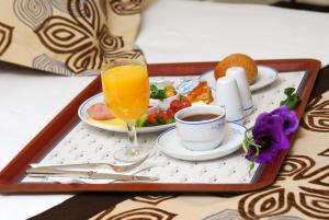 a tray of breakfast food with a glass of orange juice at Class Hotel in Ankara