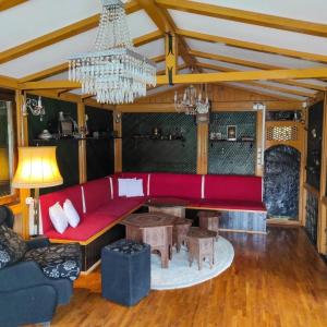 a living room with a red couch and a chandelier at Holiday Home Nur in Konjic