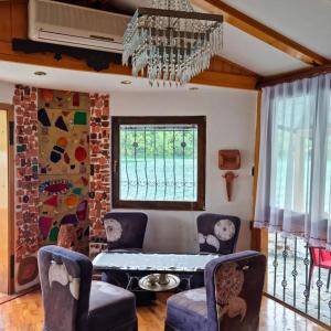 a living room with a table and chairs at Holiday Home Nur in Konjic